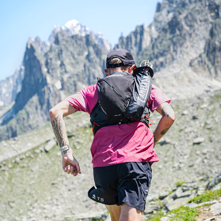 Man running with an Apex running vest