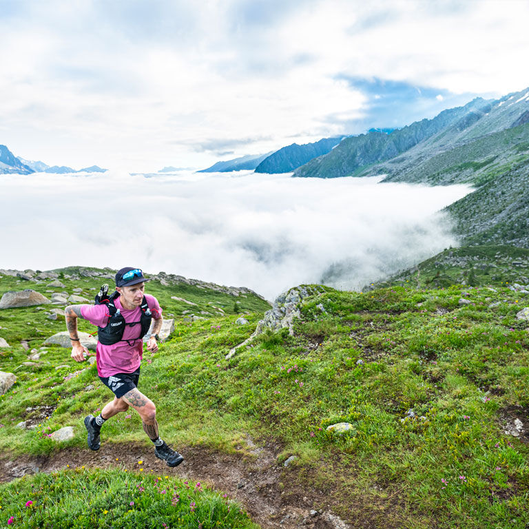 Man running with an Apex running vest
