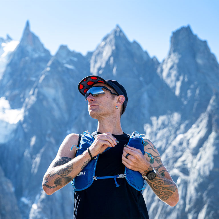 Man wearing a Zephyr Running Vest on the mountains